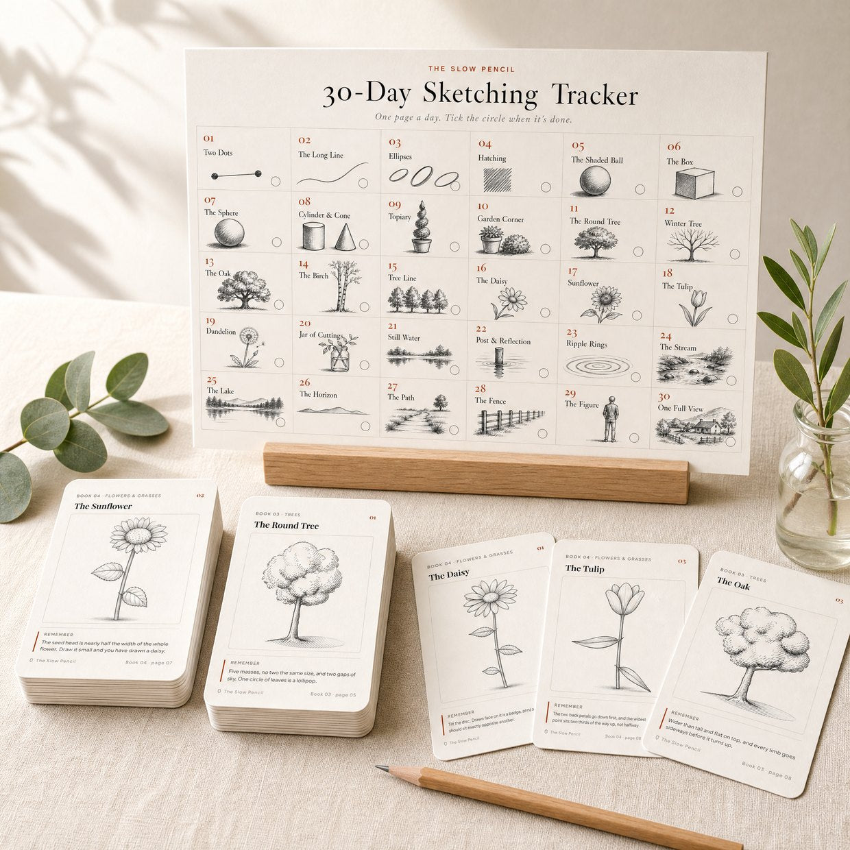 The 30-day tracker standing as a desk calendar, with stacks of pocket practice cards and three loose cards in front
